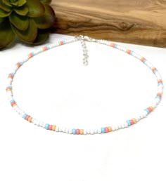 "Handmade item Made to Order * Materials * ----------------- Size 8 white, pink, light blue, and pale orange glass seed beads (approx. 3mm in size) * Dimensions * -------------------- Total Length: choose the length you want. There will be an additional 1\" extender chain for all lengths 10\" and below and a 2\" extender chain for all lengths 10.5\" and longer. * Details * ------------- Order the size you need for a bracelet, anklet or choker necklace. Each item is crafted with size 8/0 white, p Adjustable White Anklets With Colorful Beads, White Round Bead Anklets For Summer, Colorful Beaded White Anklets As Gift, White Anklets With Colorful Beads As A Gift, White Anklets With Colorful Beads For Beach, White Anklets With Colorful Beads For Gift, White Round Beads Anklet For Summer, White Beaded Anklets With Round Beads, Beach Jewelry With Pastel Beaded Details