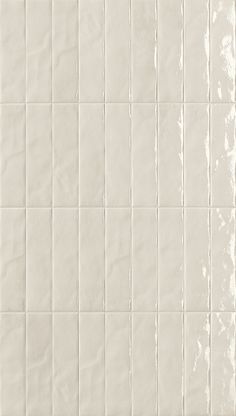 a white tiled wall with lines on it