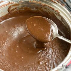 a spoon in a pot filled with chocolate