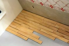 the floor is made out of wood planks and has been laid on top of it