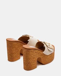 Step into style with the BREEZE mule sandal. The cork bottom and platform offer comfort and support, while the block heel adds a touch of height. The buckle detail adds a unique touch to this summer staple. 4.75 inch heel height 1.75 inch platform Synthetic upper material Leather lining Synthetic sock Synthetic sole Imported Modern Mules With Buckle Closure And Block Heel, Beige Open Heel Mules With Buckle Closure, Trendy High Heel Mules With Buckle Closure, Chic Wedge Heel Clogs With Buckle Closure, Summer Block Heel Mules With Buckle Closure, Synthetic Mules With Buckle Closure And Block Heel, Beige Open Toe Clogs With Buckle Closure, Spring Block Heel Clogs With Cork-bed Midsoles, Summer Platform Slippers With Cork-bed Midsoles