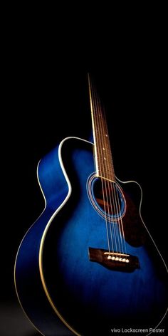 a blue acoustic guitar is shown against a black background, with the strings still attached to it