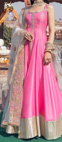 Description: A classic hot pink Peshwas featuring a hand embellished bodice with jamawaar finishing. The back has been adorned with a beautiful hand crafted gota tassel. The look is completed with an ivory floral embroidered net chaddar with sequins detailing all over and a rich multicolored border on one side. Paishwaas length: 57.5, Front depth: 9, Back depth: 9.5 Work Technique: Embellished Color: Pink Fabric: Raw silk Includes: Pishwas Pant Chaddar Disclaimer: Color may slightly vary accordi Pink Gota Work Salwar Kameez For Reception, Pink Chandbali Choli For Eid, Pink Salwar Kameez With Gota Work For Reception, Pink Silk Traditional Wear With Gota Work, Pink Salwar Kameez For Reception In Transitional Season, Pink Tissue Silk Sharara For Transitional Season, Pink Anarkali Set With Gota Work For Reception, Pink Raw Silk Anarkali Set For Navratri, Pink Silk Anarkali Set For Transitional Season