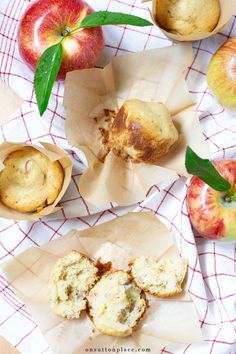 apples and muffins sitting on top of napkins next to an apple pie