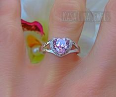 Pink and Clear Cubic Zirconia SOLID sterling stamped 925 silver Tarnish free sizes 4-12Top of ring height: 9.1mm / width: 9.1mmBand width: 5.6mm / Shank width: 1.7mmPink & clear cubic zirconiaCenter stone size: 7mm x 7mmCarat weight: 1.13 ct.Stone shape: heart shape (center) & roundTotal number of CZ stones: 17Stone setting: Prong settingHigh Polished, solid 925 sterling silver. Rhodium plated to prevent tarnishing.TARNISH FREERhodium plated to avoid tarnishingStamped 925Nothing but the best fro Pink Heart Ring, Pink Heart Rings, Vero Beach Fl, Vero Beach, October Birthstone, Pink Ring, Ring Promise, Multi Stone Ring, October Birth Stone