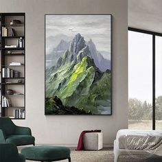 a large painting hanging on the wall above a bed in a room with a green chair