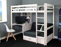 a white bunk bed sitting next to a desk