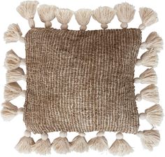 a brown and white pillow with tassels on the bottom, in front of a white background