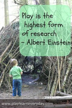 a young boy standing in front of a pile of branches with the words play is the highest form of research