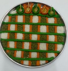 a plate that has some food on it with green peppers and carrots in the middle