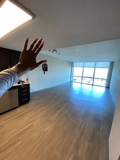 a person reaching out their hand in an empty room