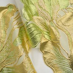 gold and green fabric with leaves on it