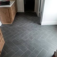 Herringbone bathroom tile Black Floor Tile Laundry Room, Slate Grey Bathroom Tile, Black Herringbone Tile Floor Entryway, Farmhouse Kitchen With Tile Floor, Slate Herringbone Tile Floor Bathroom, Kitchen Ideas With Tile Floors, Dark Bathroom Floor Tile Ideas, Herringbone Tile Floor Mudroom, Gray Slate Tile Bathroom