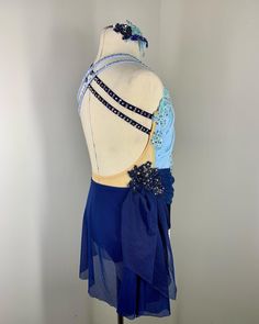 a mannequin wearing a blue dress with beaded details