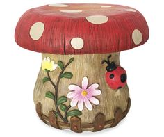 a ladybug sitting on top of a mushroom with flowers and leaves painted on it