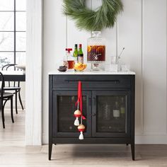 a black cabinet with christmas decorations on top