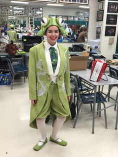 a woman dressed up as a frog in a classroom