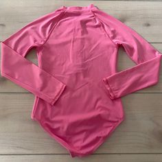 Lands End Pink Zipper Front Swimsuit. Size 10 years. Long sleeve one-piece swimsuit. Excellent used condition Long Sleeve Bodysuit For Playwear, Solid Color Long Sleeve Bodysuit For Playwear, Fitted Long Sleeve Onesie For Summer, Solid Long Sleeve Beachwear Swimwear, Fitted Long Sleeve Summer Onesie, Long Sleeve Solid Swimwear For Poolside, Solid Long Sleeve Rash Guard For Swimming, Solid Long Sleeve Swimwear For Poolside, Long Sleeve Rash Guard With Uv Protection For Playwear