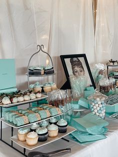 a table topped with cupcakes and desserts