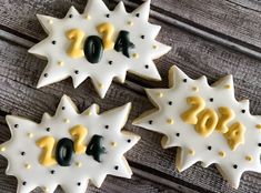 three decorated cookies with numbers and stars on them