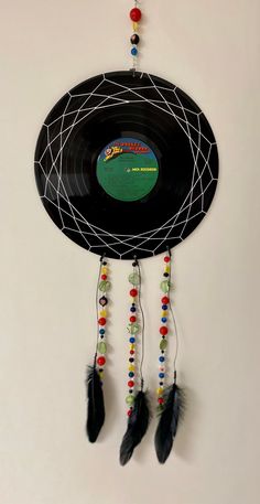 a record with beads and feathers hanging from it