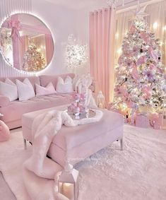 a living room decorated in pink and white with a christmas tree next to the couch