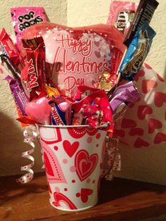 a valentine's day bucket filled with candy and candies