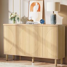 a sideboard with two vases and a lamp on it in a living room