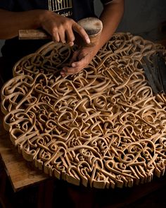 a man is working on an intricate wooden table