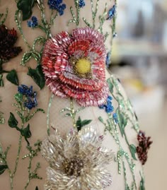 a dress with flowers and sequins on it