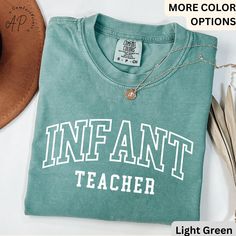 Infant Teacher Comfort Colors® T-Shirt, Infant Childcare Shirt, Infant Daycare Teacher Tee, Gift For Childcare Workers ----------------- APComfortPrints are made with premium quality materials to fit your needs. Everything is printed in the USA. - Feel free to message me if you have any questions. ----------------- Product Details: Unisex Comfort Colors 1717 *100% ring-spun cotton *Fabric weight: 6.1 oz/yd² (206.8 g/m²) *Yarn diameter: 20 singles *Garment-dyed, pre-shrunk fabric *Relaxed fit *7/ Daycare Worker Shirts, Green Relaxed Fit T-shirt With Name Print, Green Cotton T-shirt With Name Print, Green T-shirt For School, Green Relaxed Fit T-shirt For School, Daycare Teacher Shirts, Infant Childcare, Infant Teacher, Daycare Worker