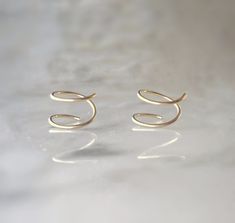 These 14k gold fill spiral earrings are the epitome of simplicity and style, perfect for your everyday look. With their minimalist design, they effortlessly enhance your style, allowing you to make a statement that reflects your unique personality. Embrace the trendy and fun vibes with these captivating spiral earrings, as they effortlessly add a touch of confidence and flair to your daily adventures. These measure 8mm. Fun Vibes, Double Twist, Artisan Earrings, Spiral Earrings, Everyday Look, Minimalist Design, Gold Filled, Best Gifts, Twist