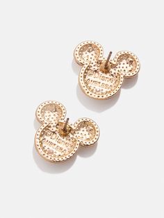 two gold mickey mouse ear clips on a white surface with the words disney written on them