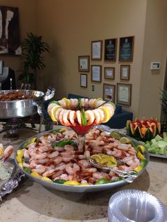 an assortment of food is displayed on a buffet table