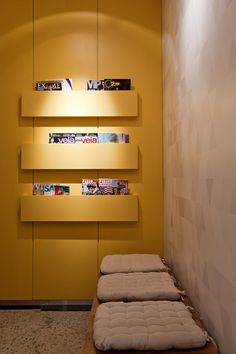 two mattresses sitting in front of a yellow wall