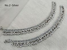 * Adjustable light weight Crystal pair of anklets/payal jewelry. *Comfortable & Light in weight. * 10 inches length. * Adjustable for anybody Ankle.   *No.1   *Width- 1 inches (Included drops)   *No.2   *Width- 1 inches ( Included drops)   *No.3   *Width- 1 inches ( Included drops)  *No.4   *Width- 1 inches ( Included drops) *No.5   *Width- 0.7 inches ( Included drops) *No.6   *Width- 0.7 inches ( Included drops) Festive Silver Beads Toe Ring Anklets, Festive Toe Ring Anklets With Silver Beads, Traditional White Anklets With Silver Beads, Festive Silver Beaded Anklets For Festivals, Traditional Silver Beaded Wedding Anklets, Silver Bracelets With Latkans For Diwali, Silver Latkans Bracelets For Diwali, Silver Anklets With Latkans For Wedding, Traditional Silver Beaded Anklets For Festive Occasions