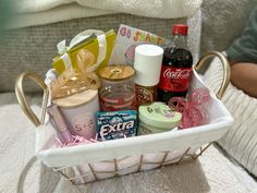 a white basket filled with lots of different types of items on top of a table