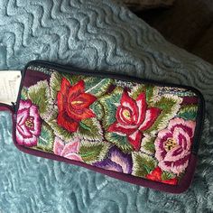 Brand New! Beautiful Embroidered Wallet/Wristlet Done In Florals. Full Zip Around Closure. Wristlet Strap Interior Fully Lined With A Center Zip Pocket, 8 Card Slots And Long Slip Pocket. Fits Most Cellphones. Handwoven From Unique Upcycled Hiupile Fabrics. Lightweight & Comfortable To Carry Wallet Is 4h X 8l Fair Trade Handmade By Women Artisans Purple Rectangular Wristlet For Travel, Purple Clutch Wristlet For Everyday Use, Rectangular Purple Wristlet As Gift, Purple Rectangular Wristlet For Gift, Rectangular Purple Coin Purse For Daily Use, Purple Pouch Wallet For Daily Use, Purple Pouch Wallet For Travel, Purple Travel Pouch Wallet, Purple Everyday Pouch Wristlet