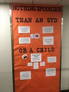 an orange bulletin board with information about children's needs and other things on it