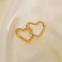 Fall in love with the playful elegance of Heart Hoops, beautifully crafted in 18k gold plating. These enchanting earrings feature a heart-shaped hoop design, perfect for adding a touch of romance and whimsy to any outfit. Trendy Gold Heart Earrings For Wedding, Gold Hypoallergenic Open Heart Hoop Earrings, Yellow Gold Heart Huggie Earrings, Gold Plated Hoop Earrings For Everyday And Valentine's Day, Valentine's Day Double Heart Tarnish Resistant Hoop Earrings, Valentine's Day Double Heart Tarnish-resistant Hoop Earrings, Gold Heart Huggie Earrings For Valentine's Day, Gold Hypoallergenic Heart Hoop Earrings, Minimalist Gold Hoop Heart Earrings