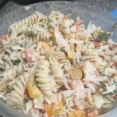 a bowl filled with pasta salad on top of a table