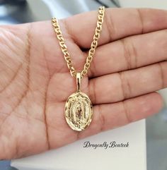 14k Gold Layard & Bonded Virgin Mary Necklace, Religious Necklace, for Women, Men Made of 14k Gold Layered and Bonded Over Semiprecious Metal. High Quality Necklace, Will Not Fade Maritime Style Chain is 3mm Thick, Flat. Guadalupe Pendant is Solid, 22mm High & 16mm in Width. Beautiful Medium Sized Necklace To care for your jewelry and keep it clean and ready to wear, gently wipe off excess make-up and skin oils after each wearing. Use a nub free, 100% cotton cloth and gently wipe the piece clean Gold Our Lady Of Guadalupe Necklace In 14k Gold, 14k Gold Necklace With Our Lady Of Guadalupe, 14k Gold Our Lady Of Guadalupe Necklace, Gold Oval Necklace With Curb Chain, 14k Gold Jewelry With Miraculous Medal, 14k Gold Miraculous Medal Jewelry In Gold, Spiritual Yellow Gold Our Lady Of Guadalupe Jewelry, Yellow Gold Oval Jewelry With Our Lady Of Guadalupe, Yellow Gold Oval Necklace With Our Lady Of Guadalupe