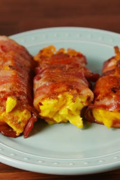 two pieces of bacon wrapped in cheese on a plate