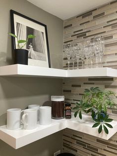 a shelf with some cups and glasses on it