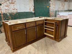 an unfinished kitchen cabinet in the process of being built with wood veneers on the floor