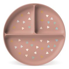 a pink plate with hearts painted on the side and two compartments for food in it