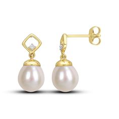 A luscious oval freshwater cultured pearl dangles from each of these splendid earrings. Styled in warm 10K yellow gold, a round diamond sparkles on each setting for a subtle hint of sparkle. The earrings secure with friction backs. Yellow Gold Diamond Earrings With Pearl Drop, Yellow Gold Diamond Dangle Pearl Earrings, Formal Yellow Gold Diamond Earrings With Pearl Drop, Classic Yellow Gold Pearl Earrings With Diamond Accents, Classic Pearl Earrings With Diamond Accents In Yellow Gold, Elegant 14k Gold Pear Shaped Earrings, Elegant Oval Diamond White Earrings, Elegant Oval Diamond White Diamond Earrings, Gold Drop Pearl Earrings With Diamond Accents