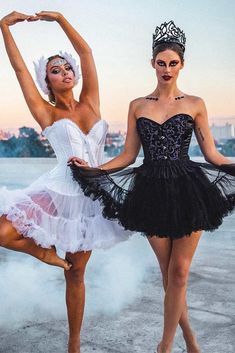 two women dressed in costumes posing for the camera