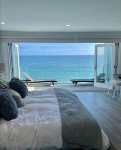 a bedroom with an ocean view is shown