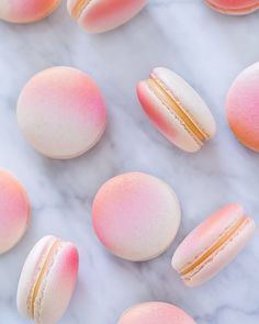 macaroons are arranged on a marble surface